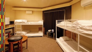 A room with bunk beds, a desk, a chair, and an air conditioning unit. - STARRY SKY COTTAGE 13 (Kitami)