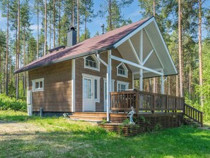 A cabin with a porch, a chimney, and a forest backdrop. - Kotaniemi by Interhome (Lieksa)