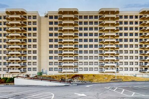 Stylish residential building with balconies and parking area.