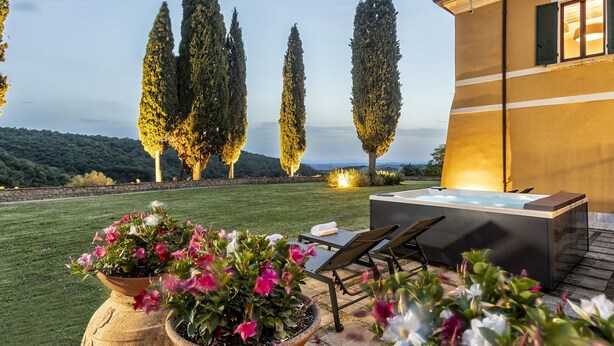 A patio with a hot tub, lounge chairs, and potted plants. - Elegant historic residence in the hills of Val d'Orcia (Montepulciano)