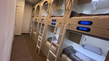 Bunk beds with numbers, a ladder, and a door.