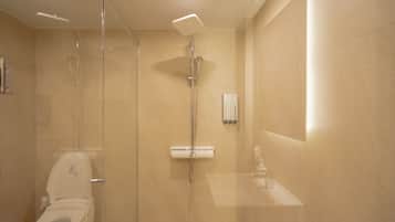A modern bathroom with a glass-enclosed shower, a toilet, and a sink.