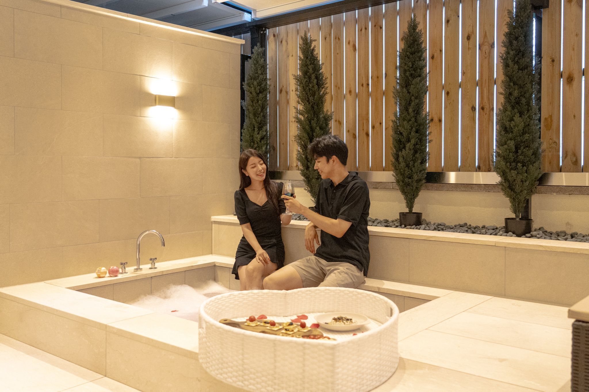 Un baño moderno con bañera, lavamanos y una pequeña zona de comedor con comida.