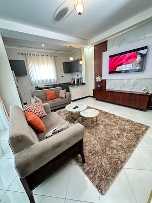 A modern living room with a sofa, coffee table, and TV.