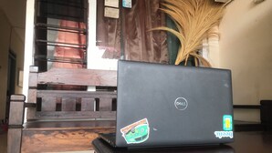 A laptop on a wooden table with a sticker that says "Be cool." - Hotel O Gunung Mas Homestay (Pemuteran)
