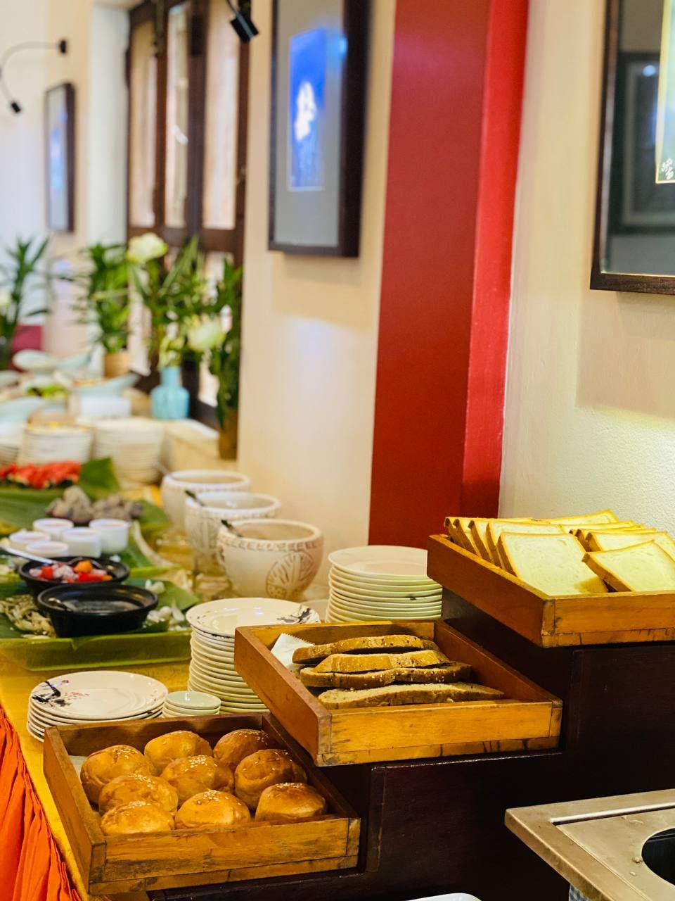 A buffet setup with various food items and dishes.