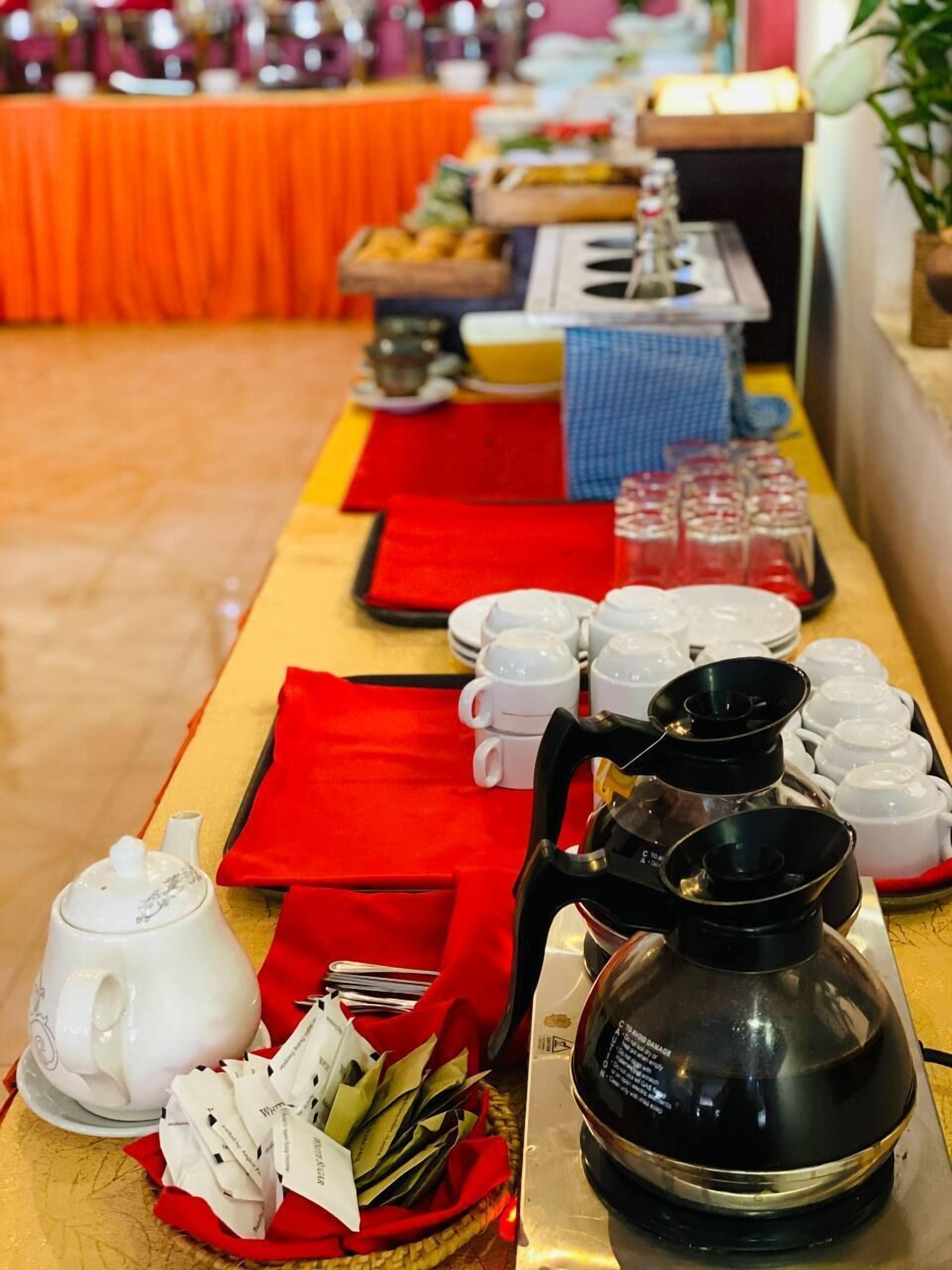 A buffet setup with various dishes and beverages.