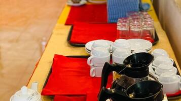 A buffet setup with various dishes and beverages.