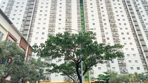 A high-rise building with multiple balconies and a sign reading "the suites". - OYO 94238 The Suite Metro Apartment By Riz Living (Bandung)