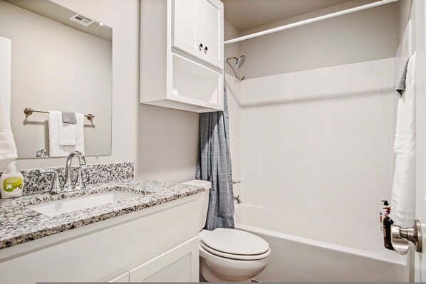A bathroom with a white sink, a toilet, and a bathtub. - Spacious 5-bedroom for Families Groups (Bethany)