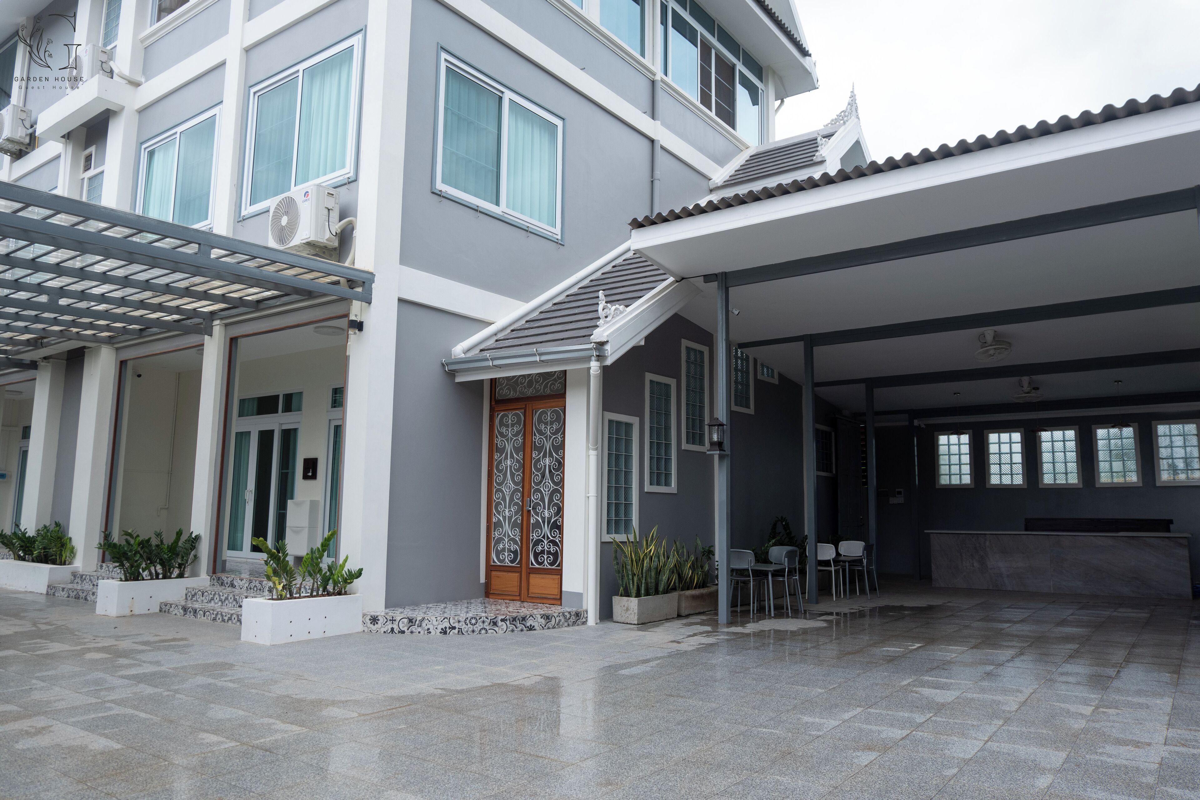 A modern building with a covered entrance, large windows, and a reception area.