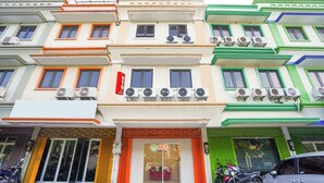 A multi-story building with a storefront at the ground level. - Hotel O Rungkut Near Its Surabaya Formerly Ace Business Hotel (Surabaya)