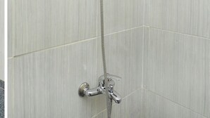 A shower with a handheld showerhead and a wall-mounted faucet. - Hotel O Rungkut Near Its Surabaya Formerly Ace Business Hotel (Surabaya)