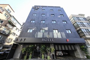 A modern hotel building with a dark facade, multiple windows, and a prominent 'HOTEL' sign at the entrance. - Eunpyeong Y HOTEL (Seoul)