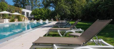 A poolside area with lounge chairs and umbrellas.