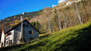 A rustic house with a sloped roof, a chimney, and a satellite dish. - CasaZefira (Feltre)