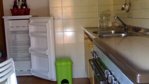 Eine Küche mit Kühlschrank, Spüle und Herd.