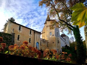 A historic building with a prominent tower and a large arched entrance.