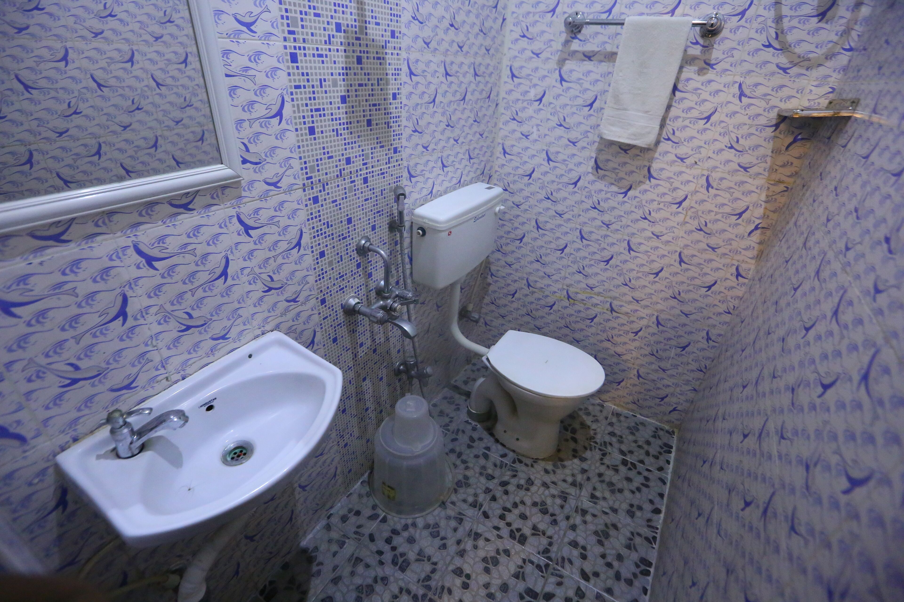 A bathroom with a sink, toilet, and shower area.