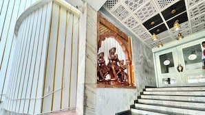 A staircase with patterned tiles leading to a room with a wooden door and a ceiling with intricate designs. - Hotel V-i sea view - Puri  (Puri)