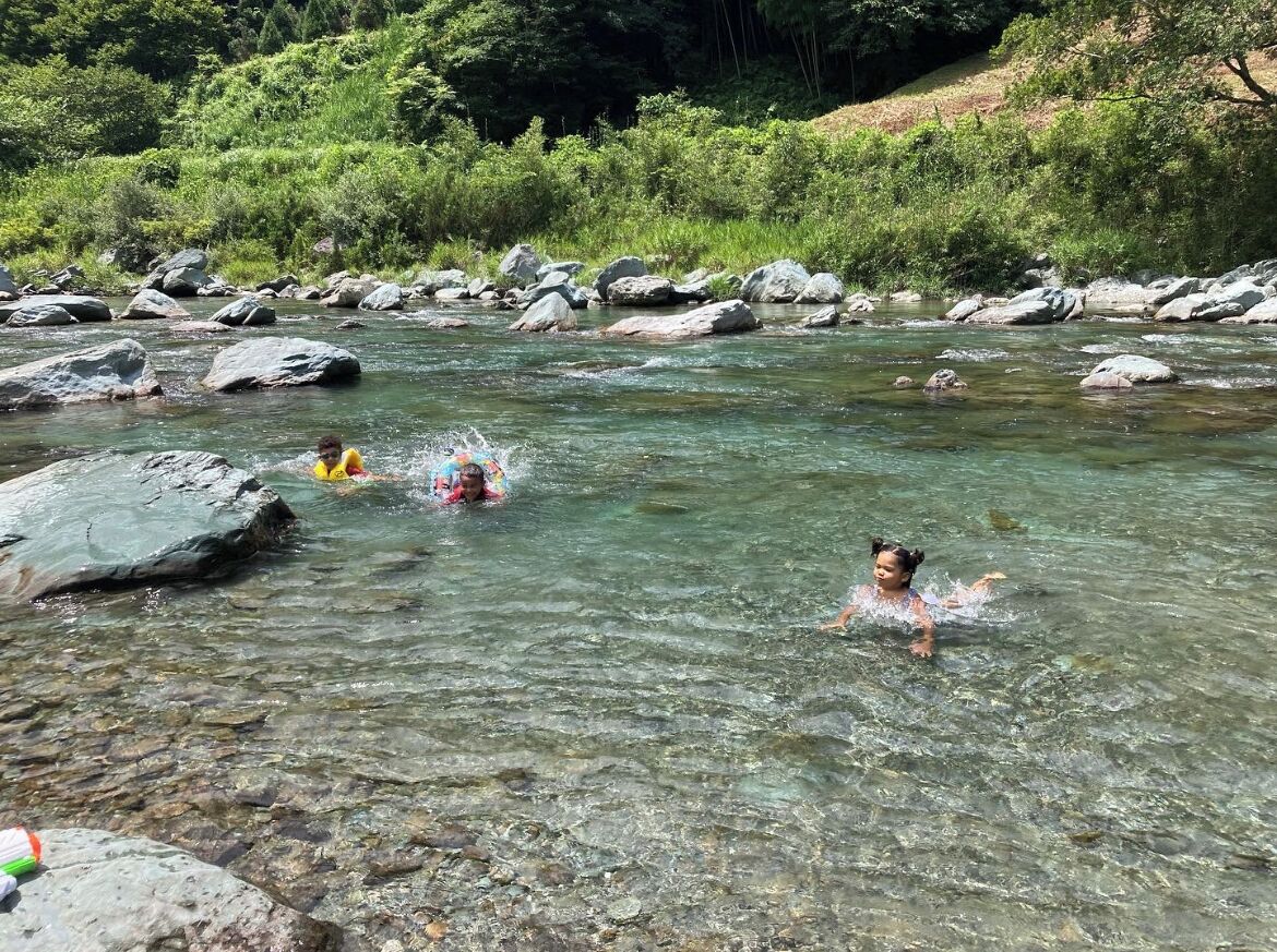 A river with clear water and large rocks.