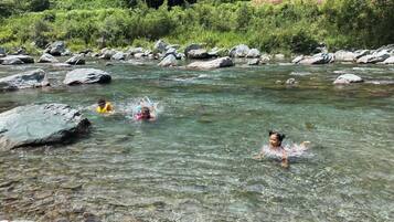 A river with clear water and large rocks.
