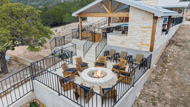 A stone building with outdoor seating and a fire pit. - The Wolves Den @ Frio River Vacation Rentals (Concan)
