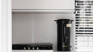 A kitchen with a stove, oven, and a coffee maker on the counter. - Chic 1 Keren Hayesod (Jerusalem)