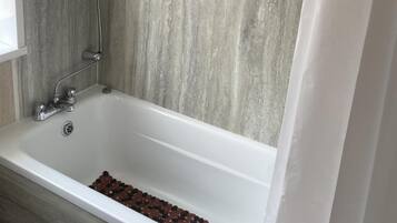 Combined shower/bathtub, deep-soaking bathtub, towels