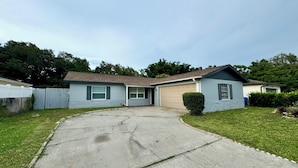 A single-story house with a front garage, a driveway, and a small front yard. - Peaceful and Beautiful Home (Brandon)