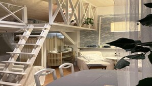 A compact, multi-level room with a loft bed, a small dining area, and a staircase. - Holiday Home in Rozewko With Pool and Orchard (gmina Bobolice)