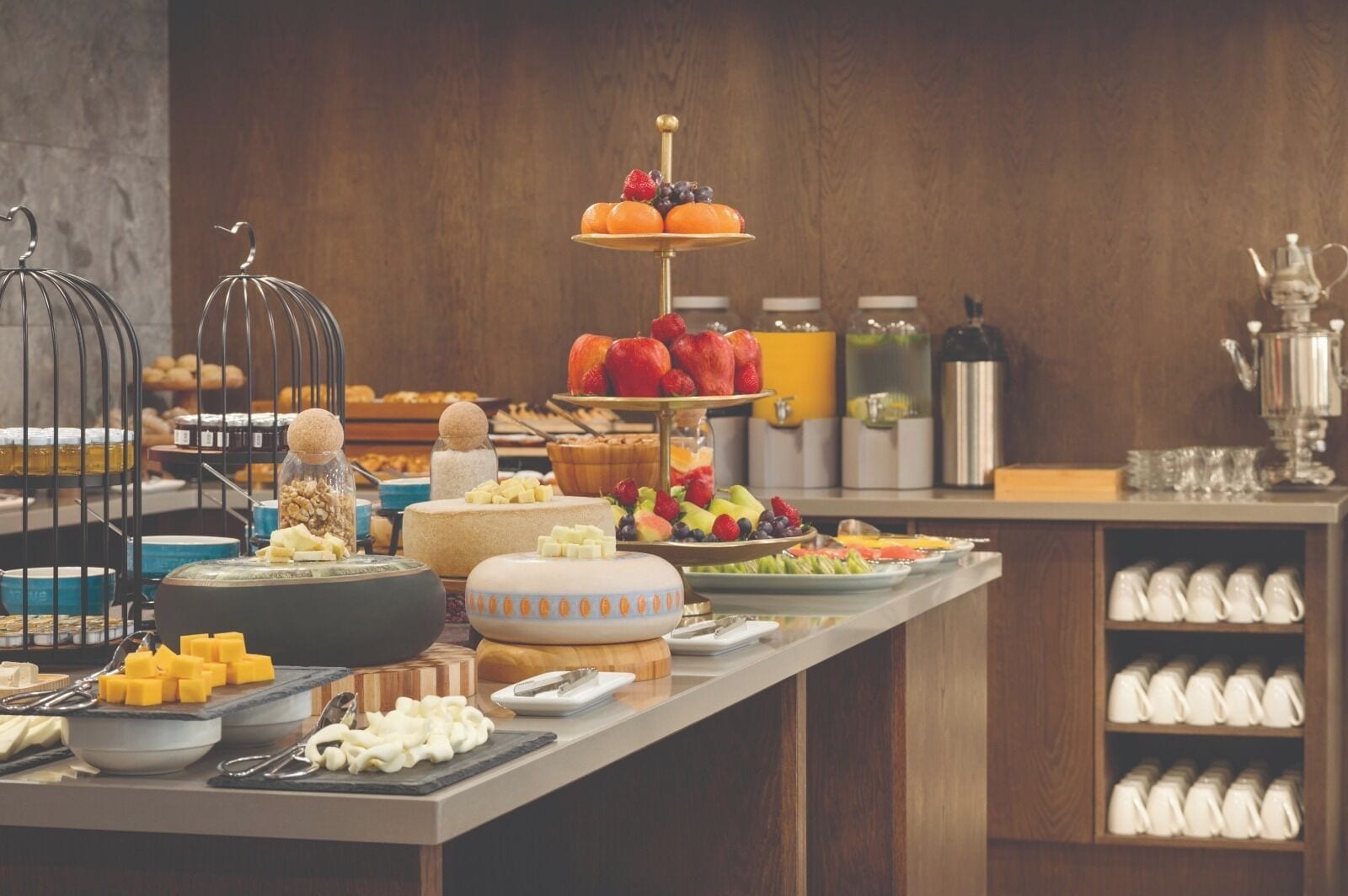 A buffet setup with various food items and utensils.