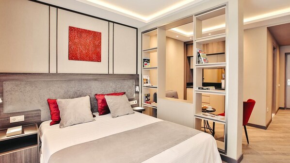 A modern hotel room with a large bed, a built-in wardrobe, and a red abstract painting on the wall. -  Sunrise Residence (Batumi)