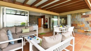 A modern living area with a sofa, coffee table, and dining table. - Holiday Home, Maspalomas (San Bartolomé de Tirajana)