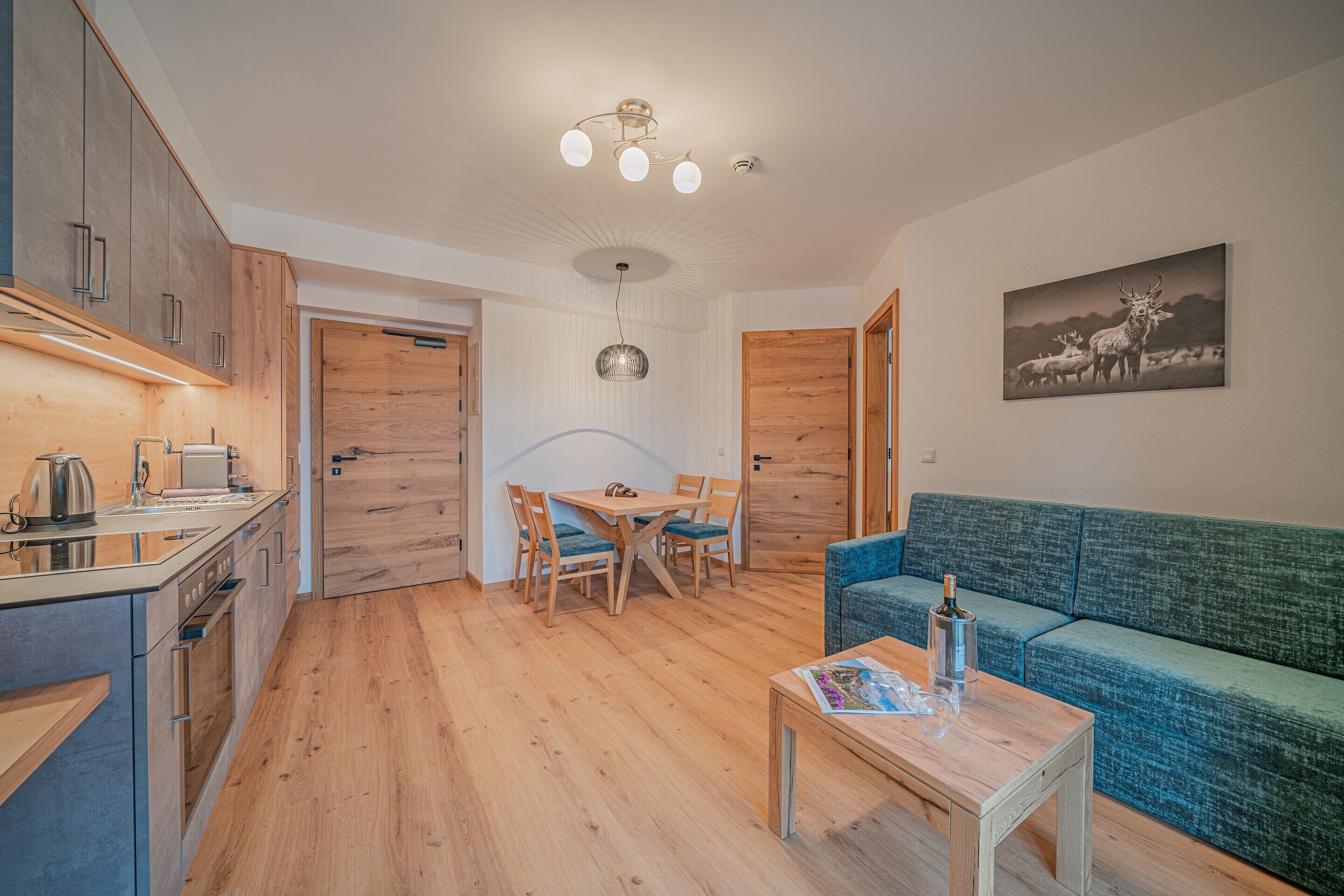 A compact living space with a kitchenette, dining area, and a sofa.