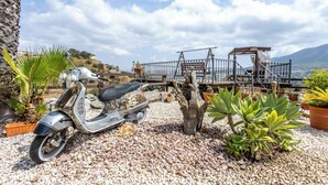 A scooter parked on gravel, a wooden swing bridge, and potted plants. - Luxurious Private Cabin Pool Hottub & Fireplace (Alhaurin el Grande)