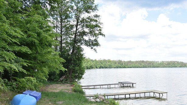 A lakeside dock with a small shelter and a covered area. - Large House by the Lake, Kashubia (Parchowo)
