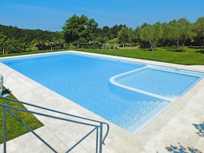 A rectangular swimming pool with a clear blue water surface, surrounded by a paved deck. - Apartment in Tuscany With Pool & Golf (Gambassi Terme)