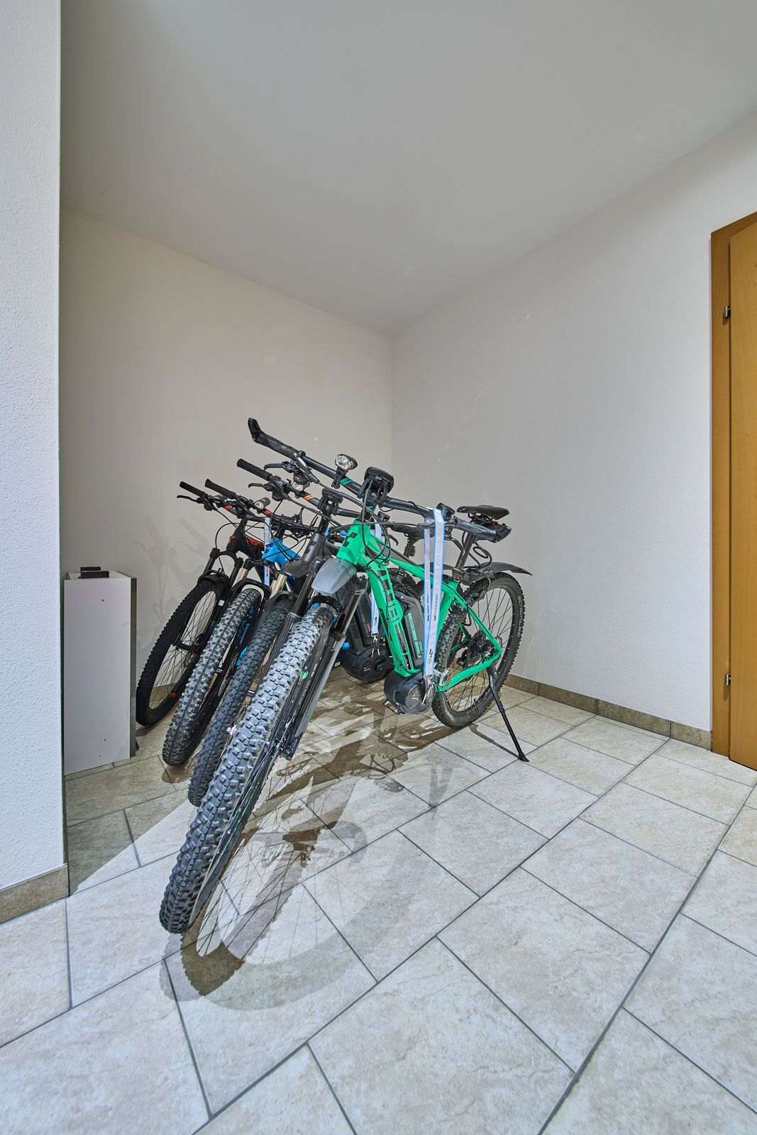 A room with a tiled floor and a wooden door.