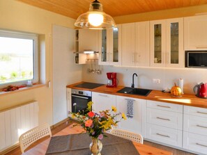 House | Private kitchen | Electric kettle, toaster, high chair - Holiday Home With Private Garden Close to the Lake (gmina Sianów)