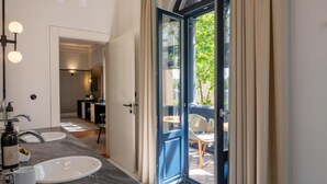 A modern bathroom with two sinks, a mirror, and a shower area. - Casa da Marechal - Boutique House by Oporto Collection (Porto)