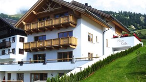 A multi-story hotel with wooden balconies and a white facade. - Chalet in Fiss With Sauna and Mountain Views (Fiss)