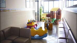 A play area with a slide, a small table, and a playhouse. - Holiday Flat in Pretty Residence With Communal Pool in Pietra Ligure (Pietra Ligure)