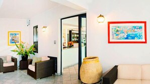 A spacious living area with a tiled floor, a large vase, and two sofas. - Holiday Flat in Pretty Residence With Communal Pool in Pietra Ligure (Pietra Ligure)