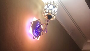 A ceiling light fixture with a decorative metal frame and a glass cover. - Cam Lodge (Tanga)