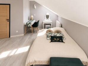 A bedroom with a bed, a desk, a chair, a mirror, and a door. - Holiday Home Kolczewo Near Lakes and Forests (gmina Wolin)