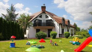 A house with a white exterior, a brown roof, and a balcony. - Villa in Brenna Near Ski Lifts & Pool (Brenna)
