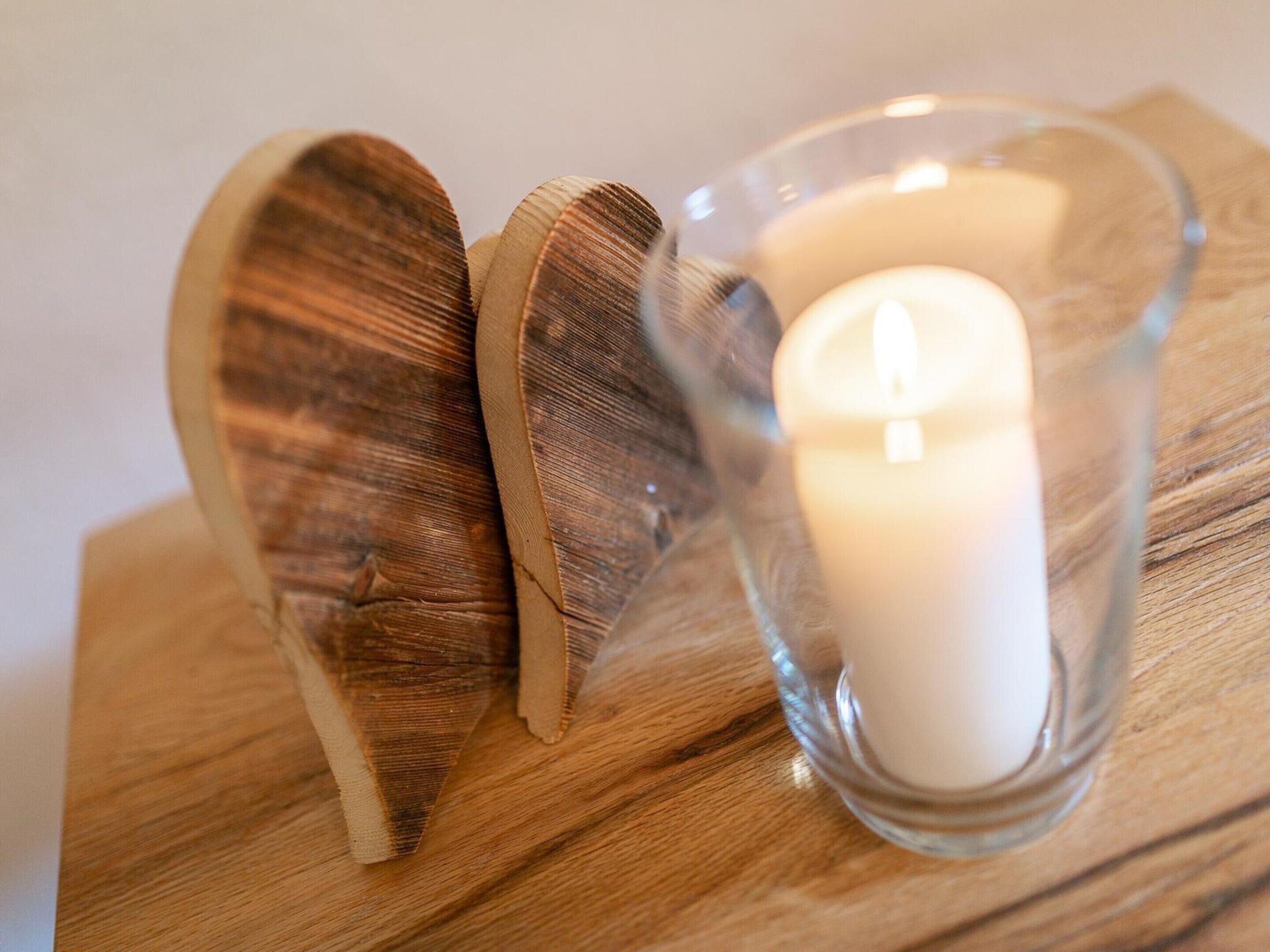A wooden object with a candle inside a glass holder.