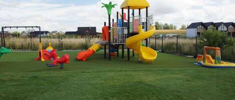 A playground with slides and climbing structures.