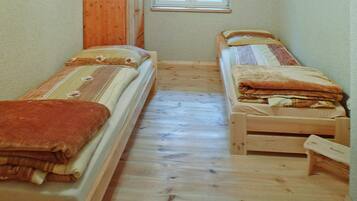 Simple, cozy room with two beds and a window.